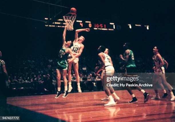 Tom Heinsohn of the Boston Celtics shoots as Kenny Sears of the New York Knicks goes for the block during an NBA game on October 25, 1958 at the...