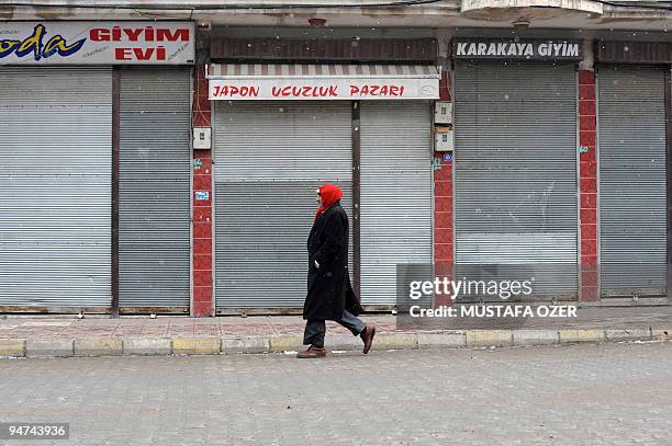 Kurdish man walks in front of the closed shops in the town of Bulanik, Mus province, on December 16 shop owners shut their businesses to protest...