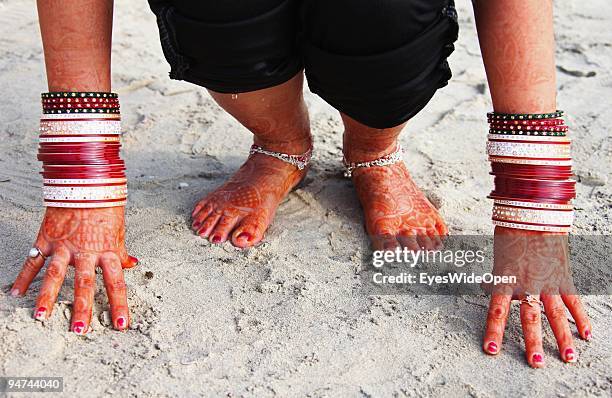 Just married woman is showing her traditional henna paintings on her hands and feet on December 13, 2009 in Kovalam Beach near Trivandrum, India....