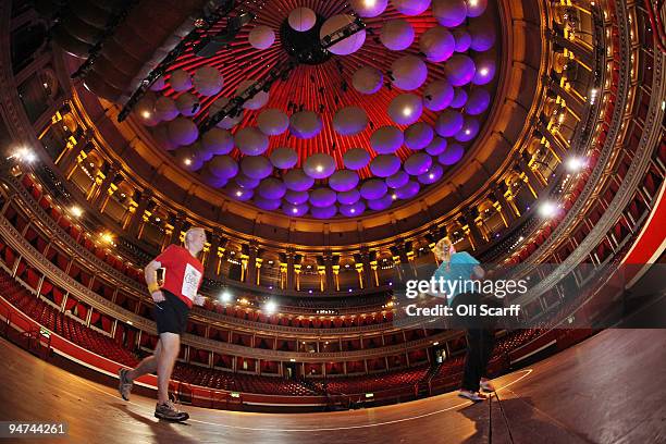 Runners from the Royal Albert Hall and the Royal Philharmonic Orchestra mark the 100 year anniversary of the first indoor marathon held in England by...