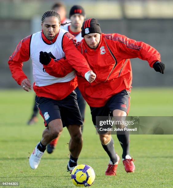 Glen Johnson battles with Andrea Dossena during a training session at Melwood Training Ground on December 18, 2009 in Liverpool, England.