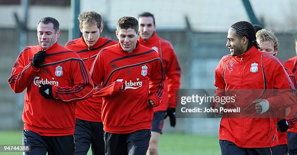 Jamie Carragher has a laugh with Steven Gerrard and Glen Johnson during a training session at Melwood Training Ground on December 18, 2009 in...