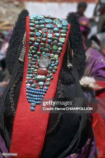 Woman wearing a perak. Women being traditionally linked to the underground and aquatic world, the dispenser of riches and fertility, they wear sawn...