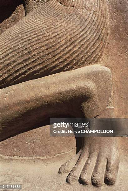 Egypt, Sethi II kneeling. Temple of Amon-Rê in Karnak, East Thebes. This larger-than-life statue is carved in sandstone and located in the hypostyle...