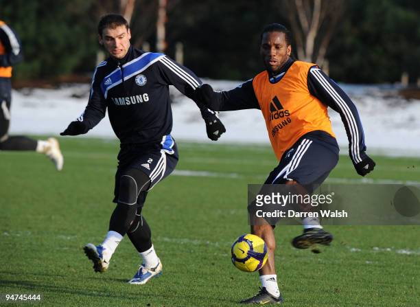 Didier Drogba and Branislav Ivanovic of Chelsea during a training session at Cobham training ground on December 18, 2009 in Cobham, England.