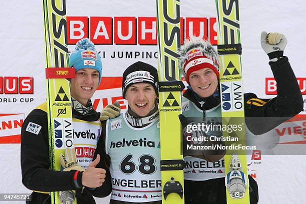 Gregor Schlierenzauer of Austria , Simon Ammann of Switzerland and Thomas Morgenstern of Austria during the flower ceremony after the Individual...