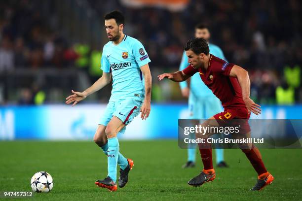 Sergio Busquets of FC Barcelona is challenged by Kevin Strootman of AS Roma during the UEFA Champions League Quarter Final, second leg match between...