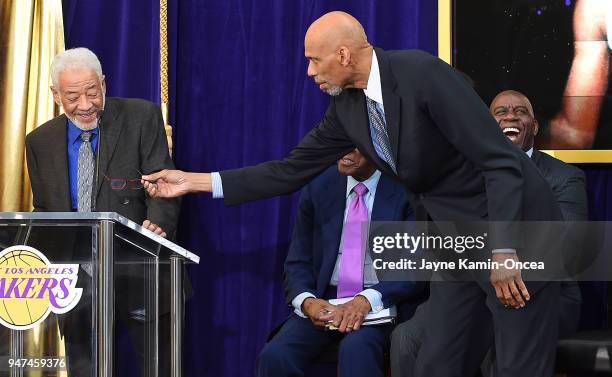 Kareem Abdul-Jabbar offers reading glasses to American singer-songwriter and musician Bill Withers as he speaks at the ceremony for the unveiling of...