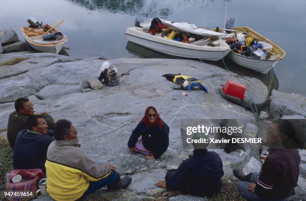 Summer camp in Sermilik Fjord . Motor boats have replaced the traditional kayaks and umiak made from waterproofed sealskin. Nowadays, the nomadic...