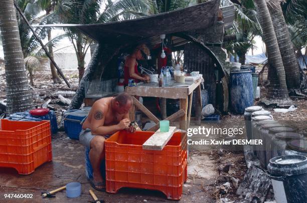 Clipperton atoll. Laurent Albenga, from the Paris Museum of Natural History, sorting and removing the organisms lodged in the coral blocks brought up...