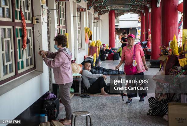 People rest at a pilgrims rest house near Xingang Fengtian Temple where a statue of Mazu is being displayed before continuing the nine day Mazu...