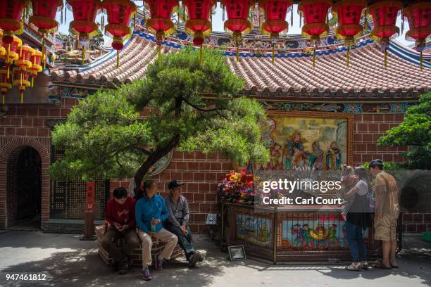 People relax in Xingang Fengtian Temple on day five of the nine day Mazu pilgrimage on April 17, 2018 in Xingang, Taiwan. The annual Mazu Pilgrimage...