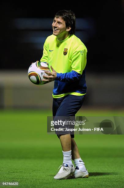 Lionel Messi of FC Barcelona holds the ball during a training session on December 18, 2009 in Abu Dhabi, United Arab Emirates. Barcelona will face...