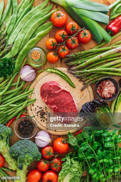 raw rib eye steak with vegetables - paleo imagens e fotografias de stock