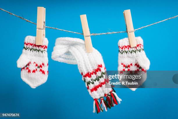 scarf and pair of gloves drying on the rope - rope clip stock pictures, royalty-free photos & images