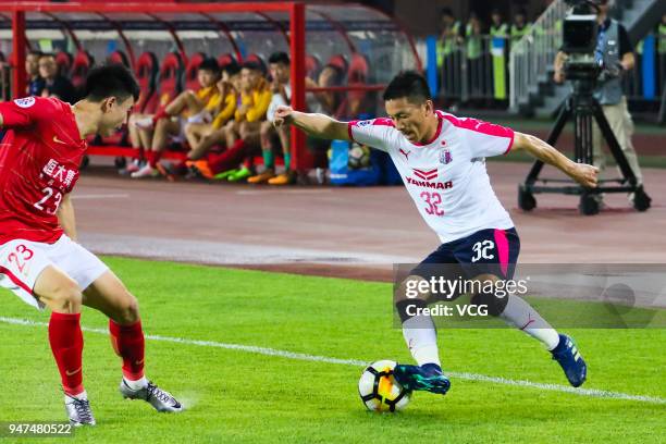 Deng Hanwen of Guangzhou Evergrande and Atomu Tanaka of Cerezo Osaka compete for the ball during the AFC Champions League Group G match between...