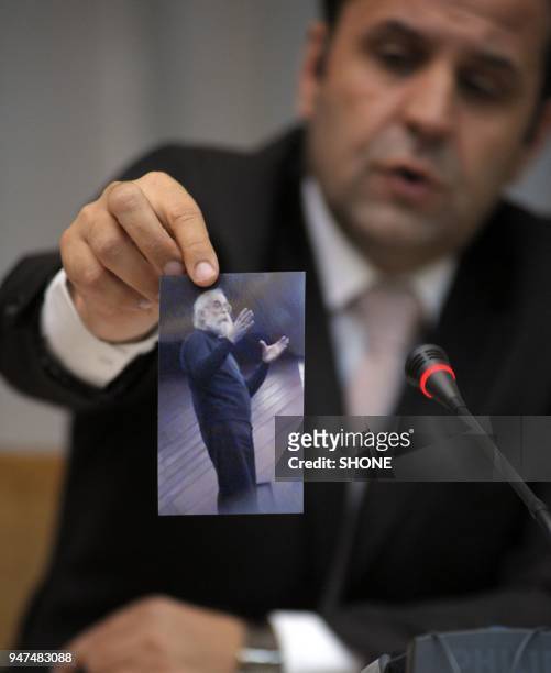Rsim Ljajic, the Serbian minister for relations with the international war crimes tribunal in The Hague holds a photo of Radovan Karadzic on the day...