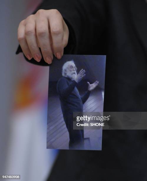 Rsim Ljajic, the Serbian minister for relations with the international war crimes tribunal in The Hague holds a photo of Radovan Karadzic on the day...