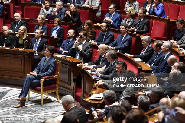 Canadian Prime Minister Justin Trudeau sits in front of members of the French Government prior to delivering a speech at the French National Assembly...