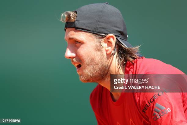 France's Lucas Pouille reacts during his tennis match against Germany's Mischa Zverev as part of the Monte-Carlo ATP Masters Series Tournament, on...