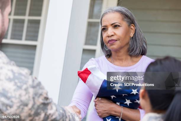senior woman receives news of her son's military death - poland flag stock pictures, royalty-free photos & images