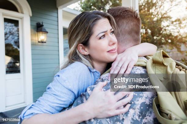 upset military wife dreads her husband's departure - military rucksack stock pictures, royalty-free photos & images