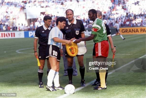 Diego Maradona of Argentina and Stephen Tataw of Cameroon with the referee during the opening match of the 1990 World Cup between Cameroon and...