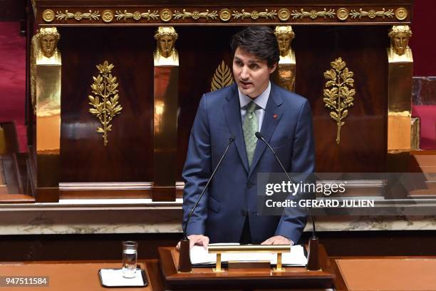 French lawmakers applaud as Canadian Prime Minister Justin Trudeau delivers a speech at the French National Assembly in Paris, on April 17 as part of...