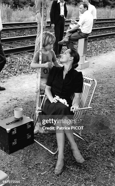 Romy Schneider with her son david on the set of '"Le train" by Pierre Granier Deferre, 1973.