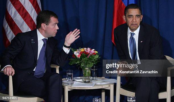 President Barack Obama sits with his Russian counterpart Dmitry Medvedev after the session of United Nations Climate Change Conference December 18,...