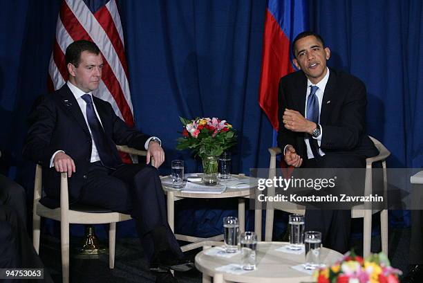 President Barack Obama talks with his Russian counterpart Dmitry Medvedev after the session of United Nations Climate Change Conference December 18,...