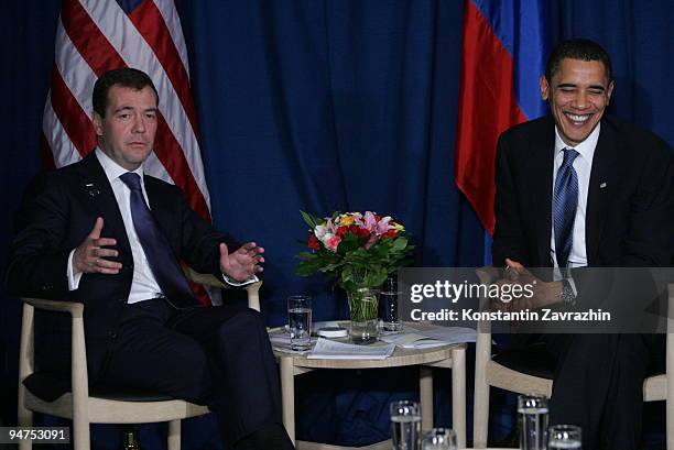 President Barack Obama laughs beside with his Russian counterpart Dmitry Medvedev after the session of United Nations Climate Change Conference...