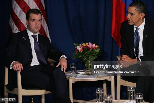 President Barack Obama sits with his Russian counterpart Dmitry Medvedev after the session of United Nations Climate Change Conference December 18,...