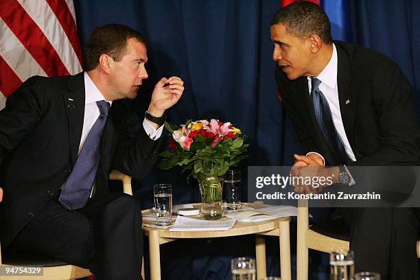 President Barack Obama talks with his Russian counterpart Dmitry Medvedev after the session of United Nations Climate Change Conference December 18,...