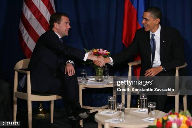 President Barack Obama shakes hands with his Russian counterpart Dmitry Medvedev after the session of United Nations Climate Change Conference...