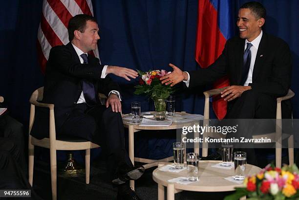 President Barack Obama shakes hands with his Russian counterpart Dmitry Medvedev after the session of United Nations Climate Change Conference...