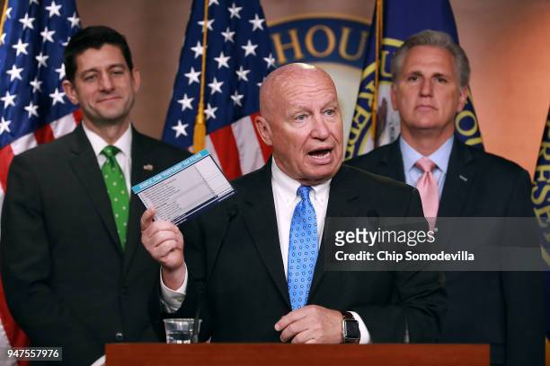 House Ways and Means Committee Chairman Kevin Brady holds up an example tax form during a news conference with Speaker of the House Paul Ryan and...