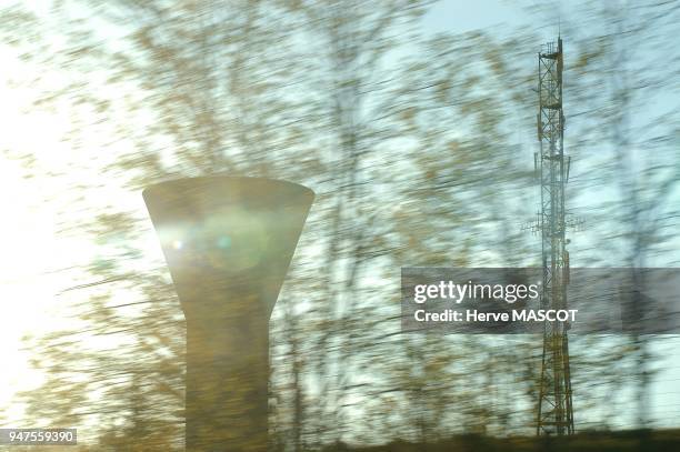 Water tower, France, Chateau d'eau et relais electrique sur fond de ciel bleu.Le paysage alentour est flou.