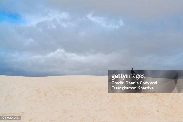 walking on a sand dune - alamogordo stock pictures, royalty-free photos & images