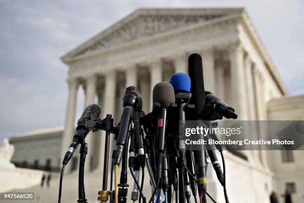 television microphones stand outside the u.s. supreme court - us supreme court fotografías e imágenes de stock