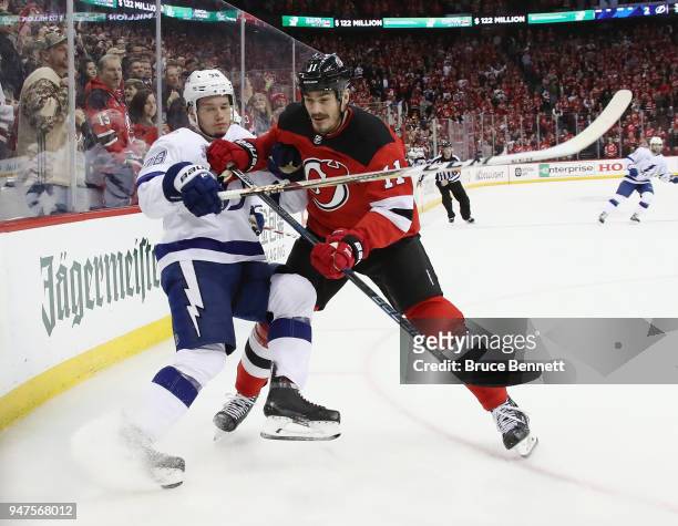 Brian Boyle of the New Jersey Devils checks Mikhail Sergachev of the Tampa Bay Lightning in Game Three of the Eastern Conference First Round during...