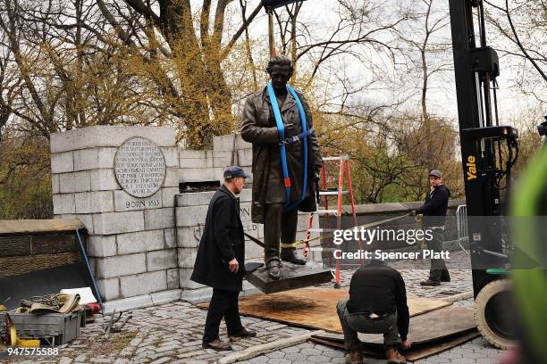Statue of J. Marion Sims, a surgeon celebrated by many as the father of modern gynecology, is loaded onto a Parks Department truck after being taken...