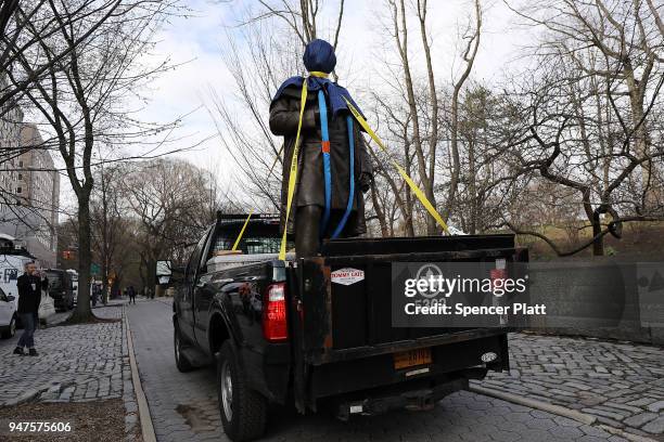 Statue of J. Marion Sims, a surgeon celebrated by many as the father of modern gynecology, is driven away in a Parks Department truck after being...