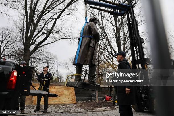 Statue of J. Marion Sims, a surgeon celebrated by many as the father of modern gynecology, is loaded onto a Parks Department truck after being taken...