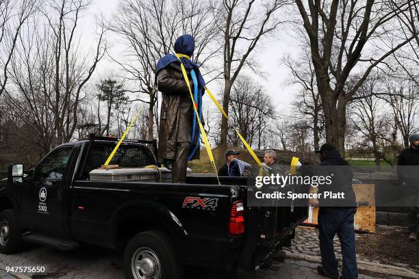 Statue of J. Marion Sims, a surgeon celebrated by many as the father of modern gynecology, is loaded onto a Parks Department truck after being taken...