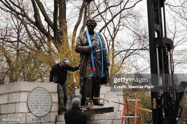 Statue of J. Marion Sims, a surgeon celebrated by many as the father of modern gynecology, is taken down from its pedestal by Parks Department...