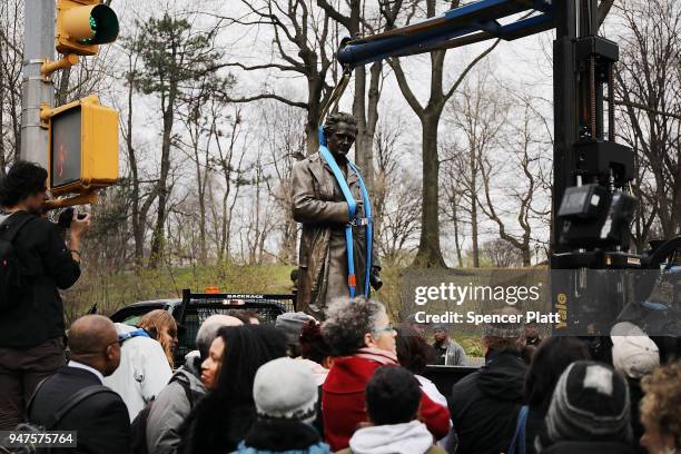 Statue of J. Marion Sims, a surgeon celebrated by many as the father of modern gynecology, is driven away in a Parks Department truck after being...