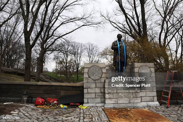 Harness is placed over the statue of J. Marion Sims, a surgeon celebrated by many as the father of modern gynecology, before it is taken down from...