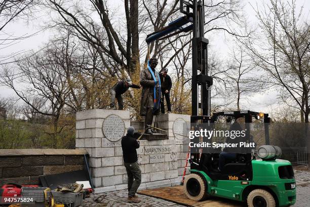 Statue of J. Marion Sims, a surgeon celebrated by many as the father of modern gynecology, is taken down from its pedestal by Parks Department...