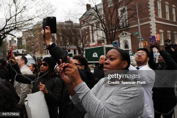 People gather to watch the removal of a statue of J. Marion Sims, a surgeon celebrated by many as the father of modern gynecology, at Central Park...